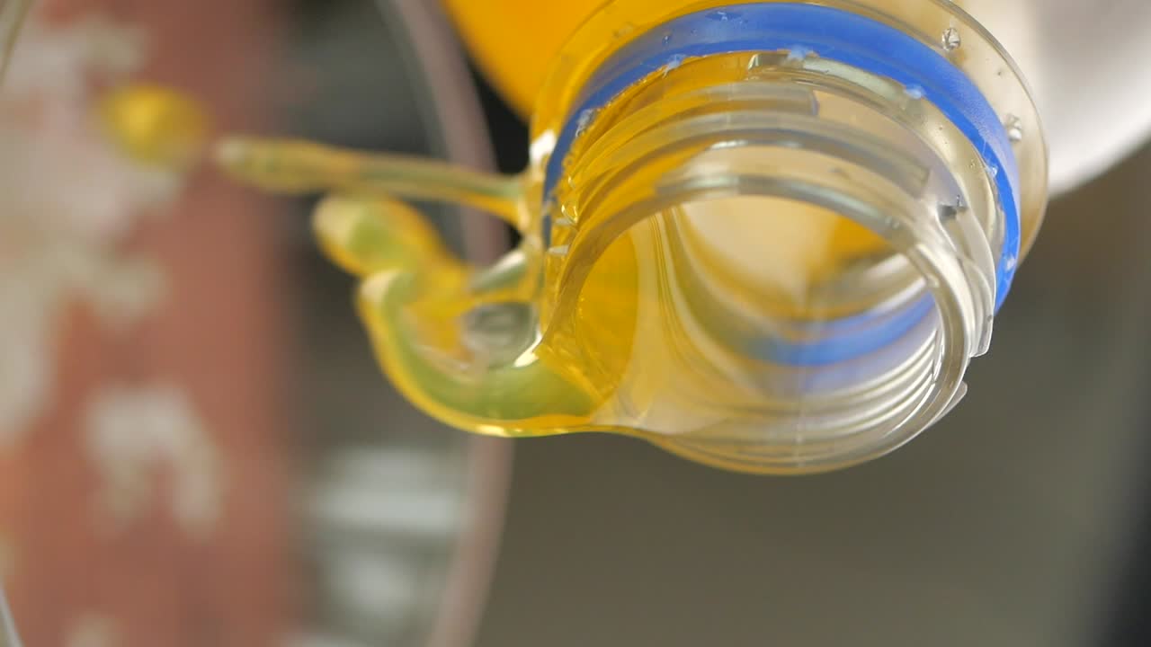 Pouring orange juice from a bottle
