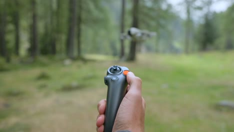 controlling flying drone with joystick, close-up and blurred background