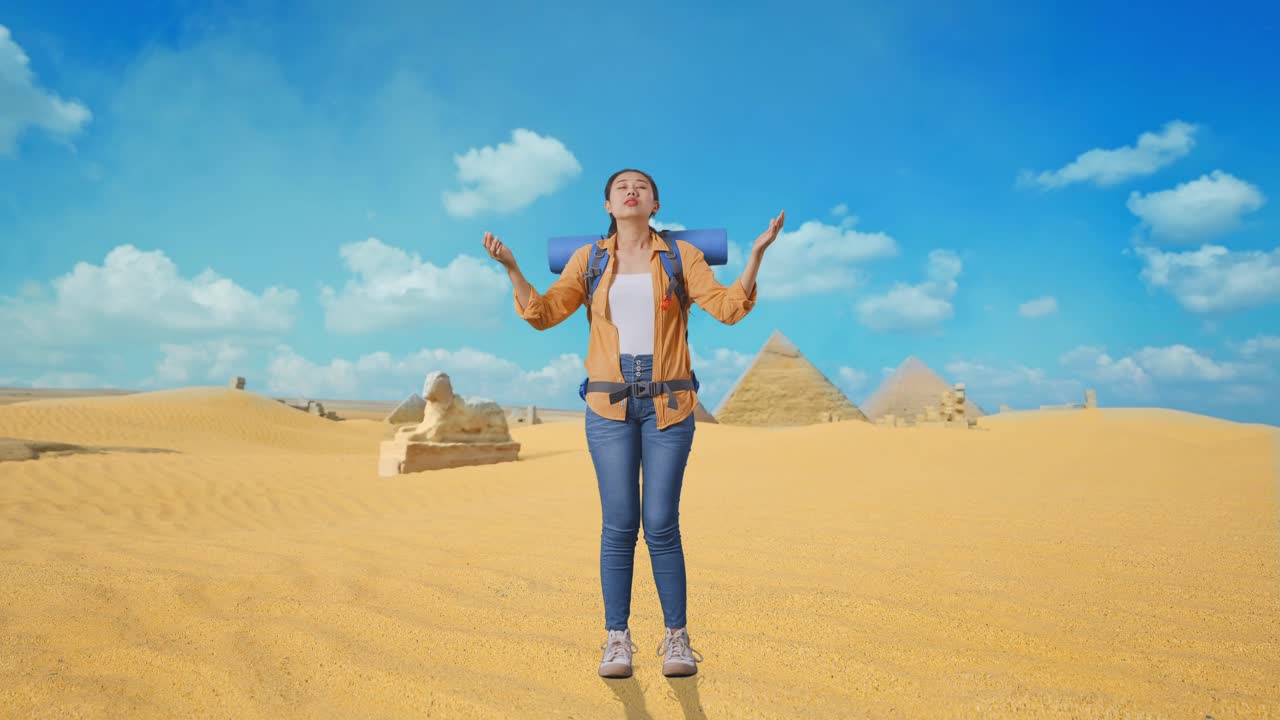 Full Body Of Asian Female Hiker With Mountaineering Backpack Spreading Arms Enjoy Looking The View Around While Traveling In Pyramid Of Giza