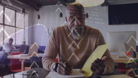 Animation of arrows, graphs and trading over african american man discussing on video call