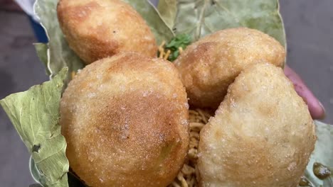 Close-up-shot-of-Club-Kachori-served-in-Sal-leaves-plate-in-road-side-India