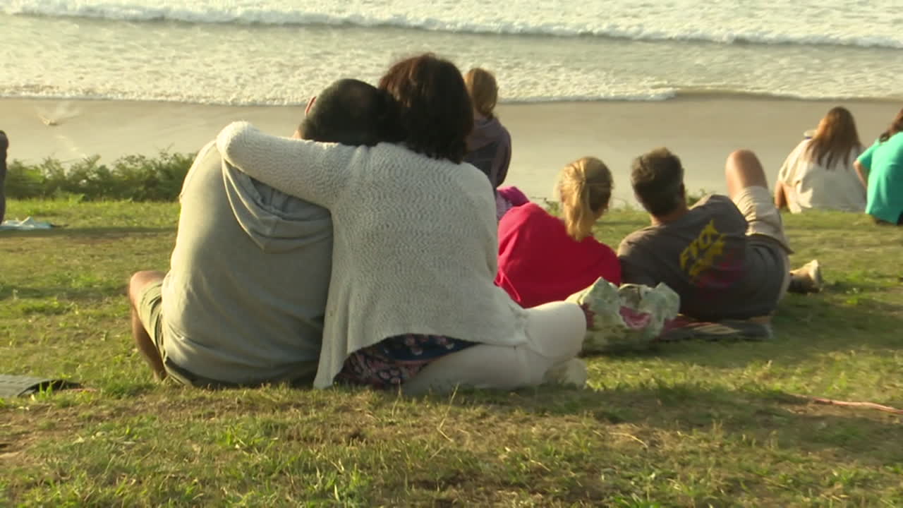 Couple and Family Watching Waves at the Beach
