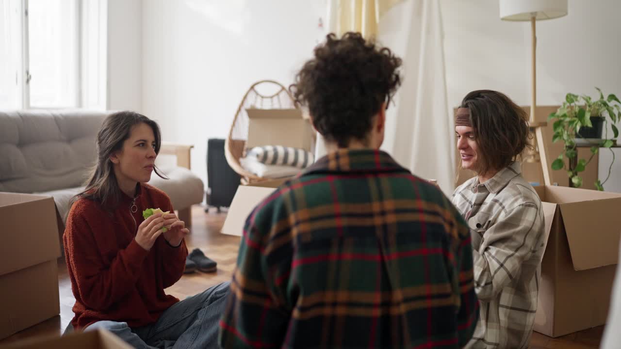 Friends Relaxing and Eating During a Move