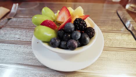 fresh and vibrant fruit bowl: grapes, strawberries, blueberries, mango, 4k