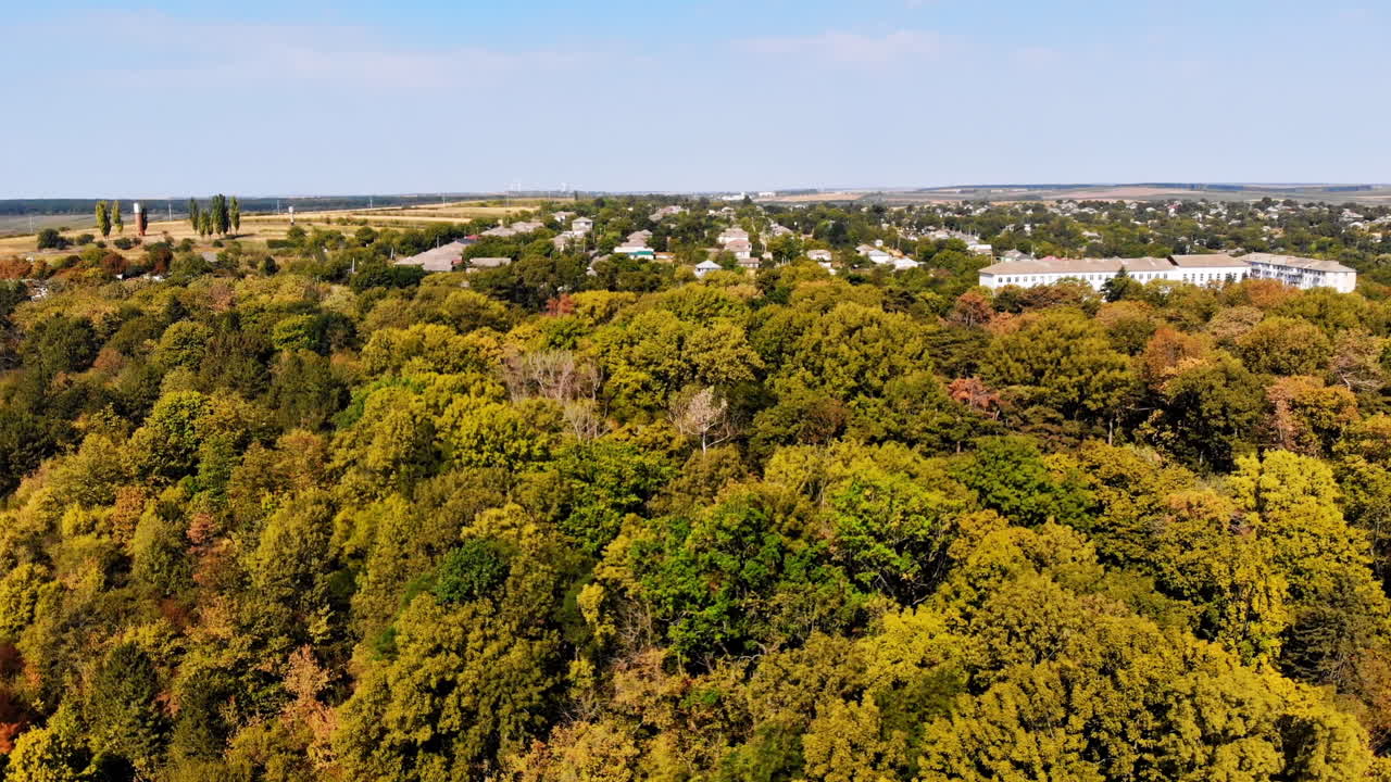 Aerial drone view of green hills, fields and small village in Moldova. Panoramic shot