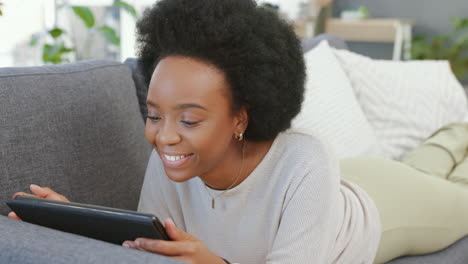 Laughing-afro-woman-using-digital-tablet-to-stream