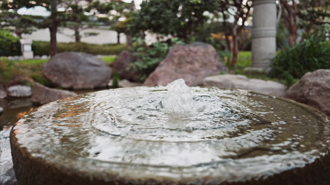 Small water fountain in the Princess Grace Japanese Garden City park in Monaco