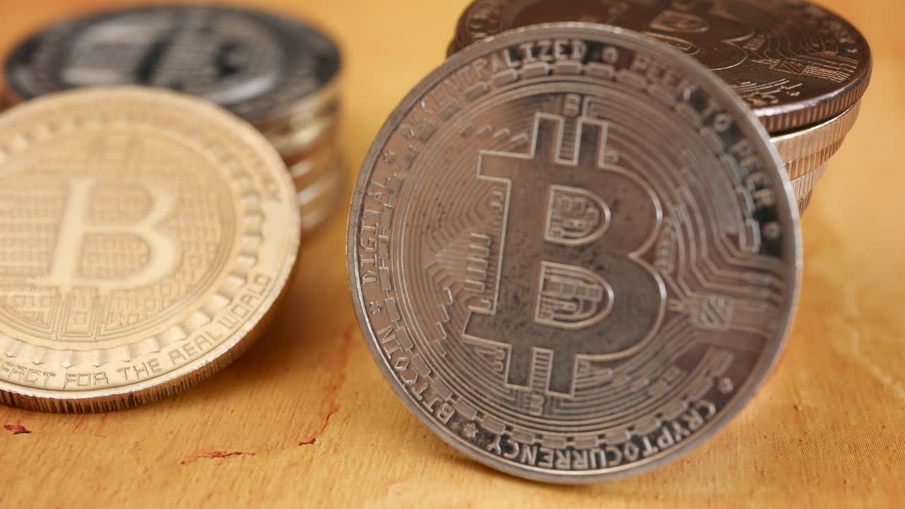 Close up of shiny physical Bitcoin coins stacked on a table