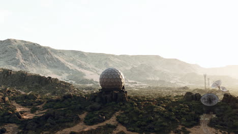 futuristic desert outpost with satellite dishes and radar dome