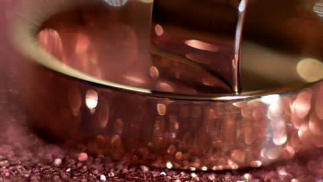 wedding rings lying on shiny surface shining with light close up macro. rotate counterclockwise