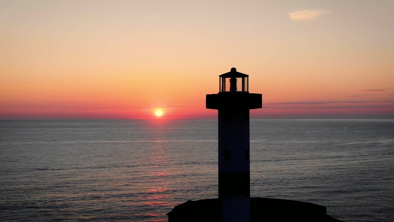 4K drone footage of lighthouse at sunset overlooking the Pacific ocean