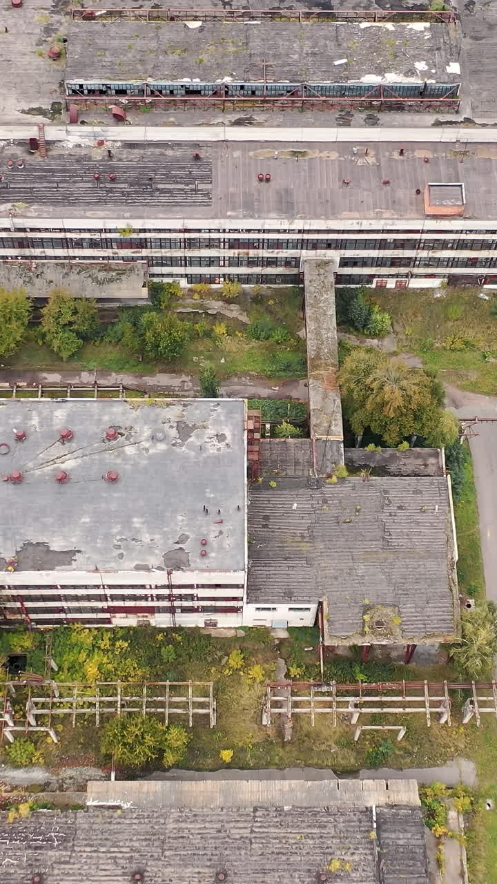 Industrial big destroted factory. Aerial view of factory constructions. Vertical video