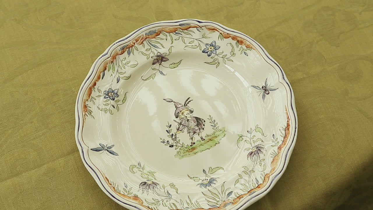 Tracking shot of a waiter with white gloves putting plates on a fancy table