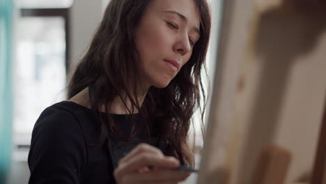 woman painting on canvas