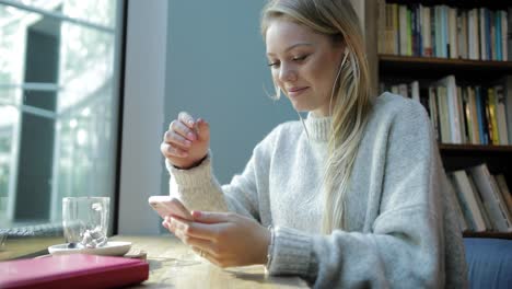 Woman-using-smartphone-and-listening-to-music