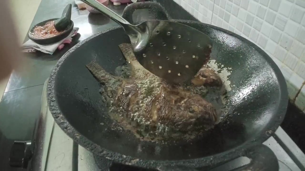 Chef Frying Whole Fish in a Wok