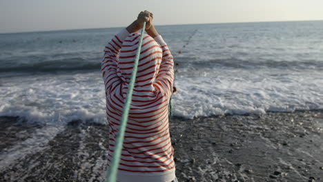 child fishing at the beach