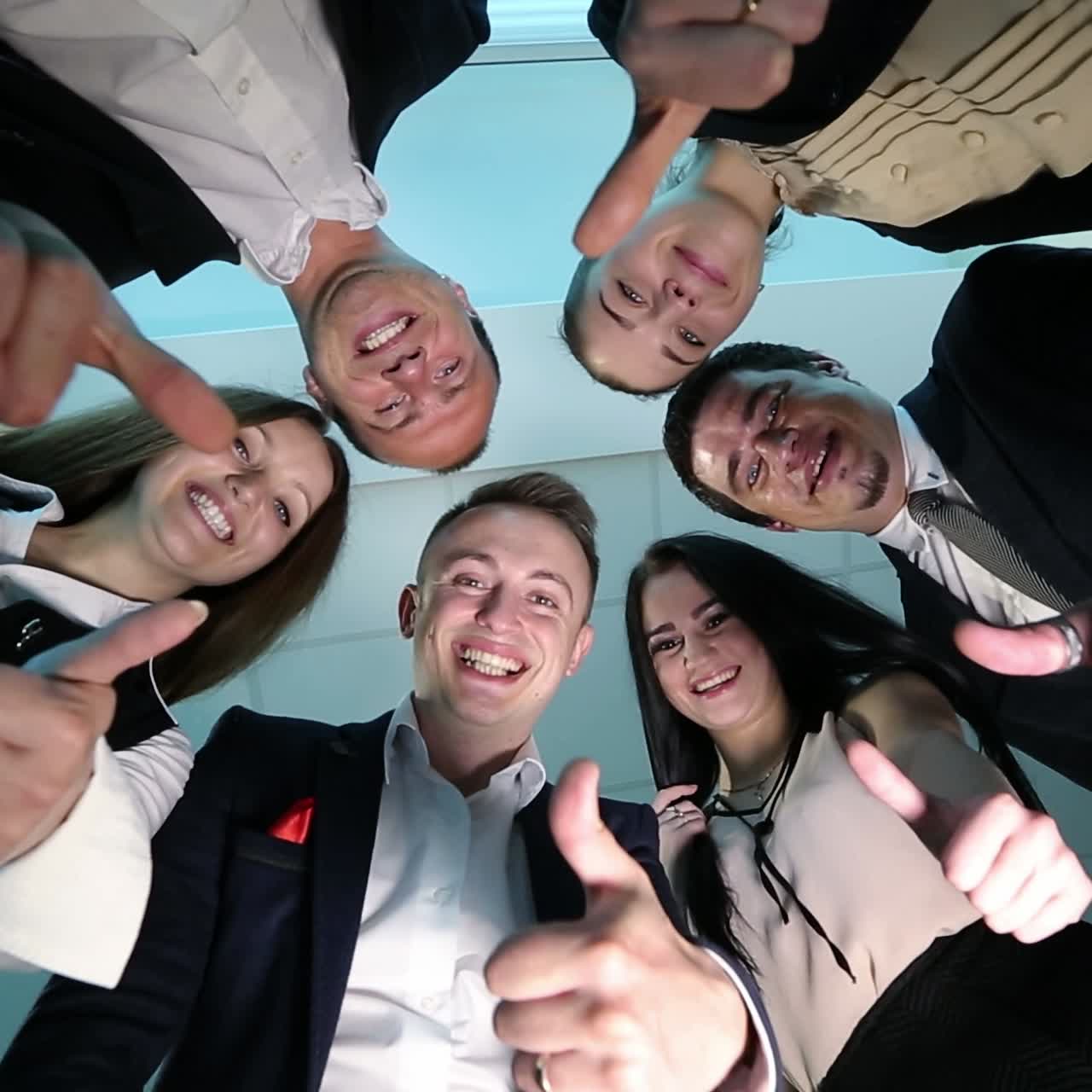 Happy Business Team With Thumbs Up