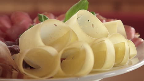 switzerland dish with shaved pieces of air-dried meat, bacon, ham, and cheese on rotating plate