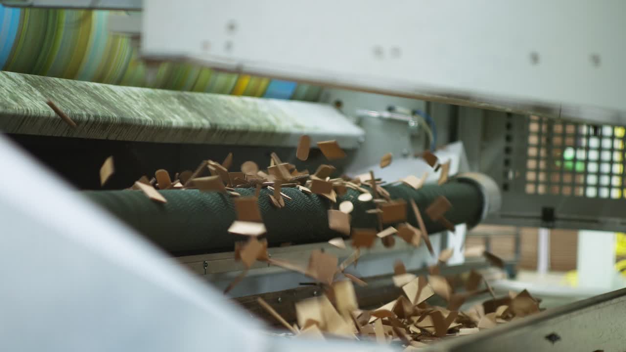 SLOW MOTION CLOSE UP SHOT OF RESIDUE AND CARDBOARD CUTTING OF CARDBOARD BOXES