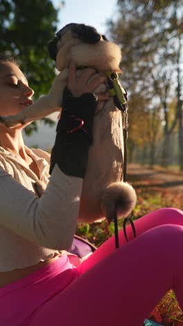 woman with a puppy in a park