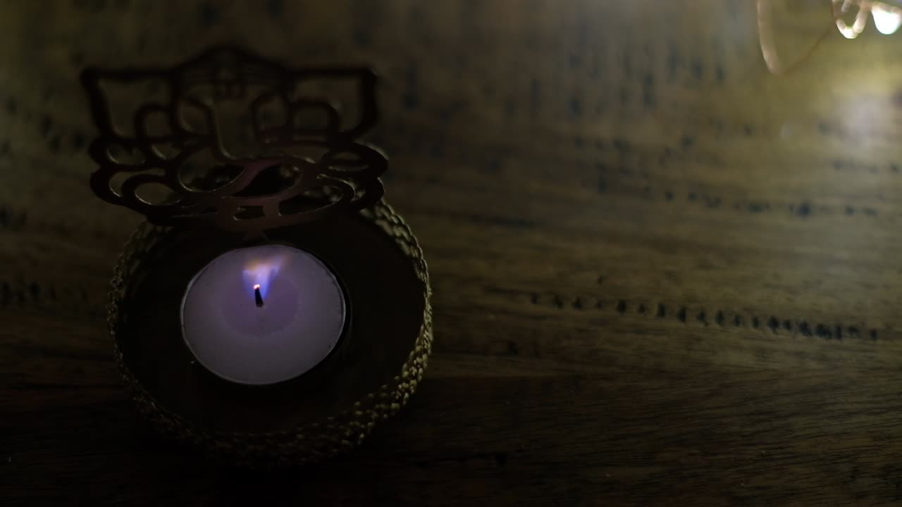 Closeup of a golden tea light holder cutout of Hindu God Ganesha to worship  during the festival of lights or Diwali or Deepawali