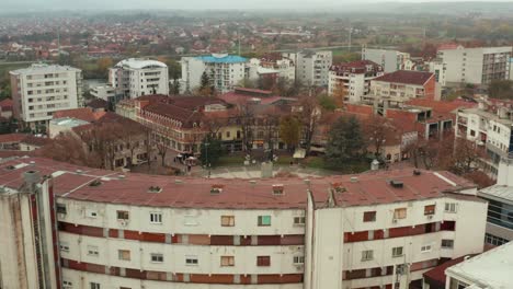 buildings around central square in kraljevo, serbia with monument to a serbian soldier in the middle