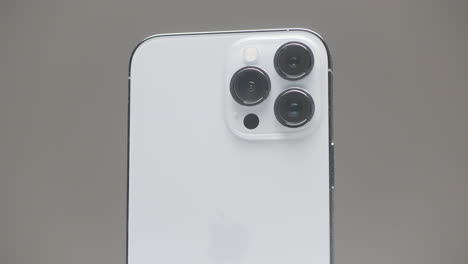 close-up of a white iphone with quad-lens camera