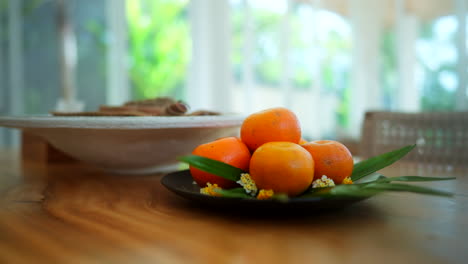 mandarin oranges on wooden table at luxury villa in ubud, bali, indonesia