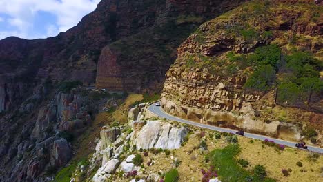 Aerial-of-two-motorcycles-traveling-on-the-beautiful-coastline-and-narrow-roads-south-of-Cape-Town-South-Africa