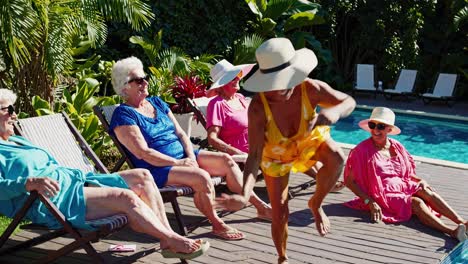 senior women relaxing by the pool