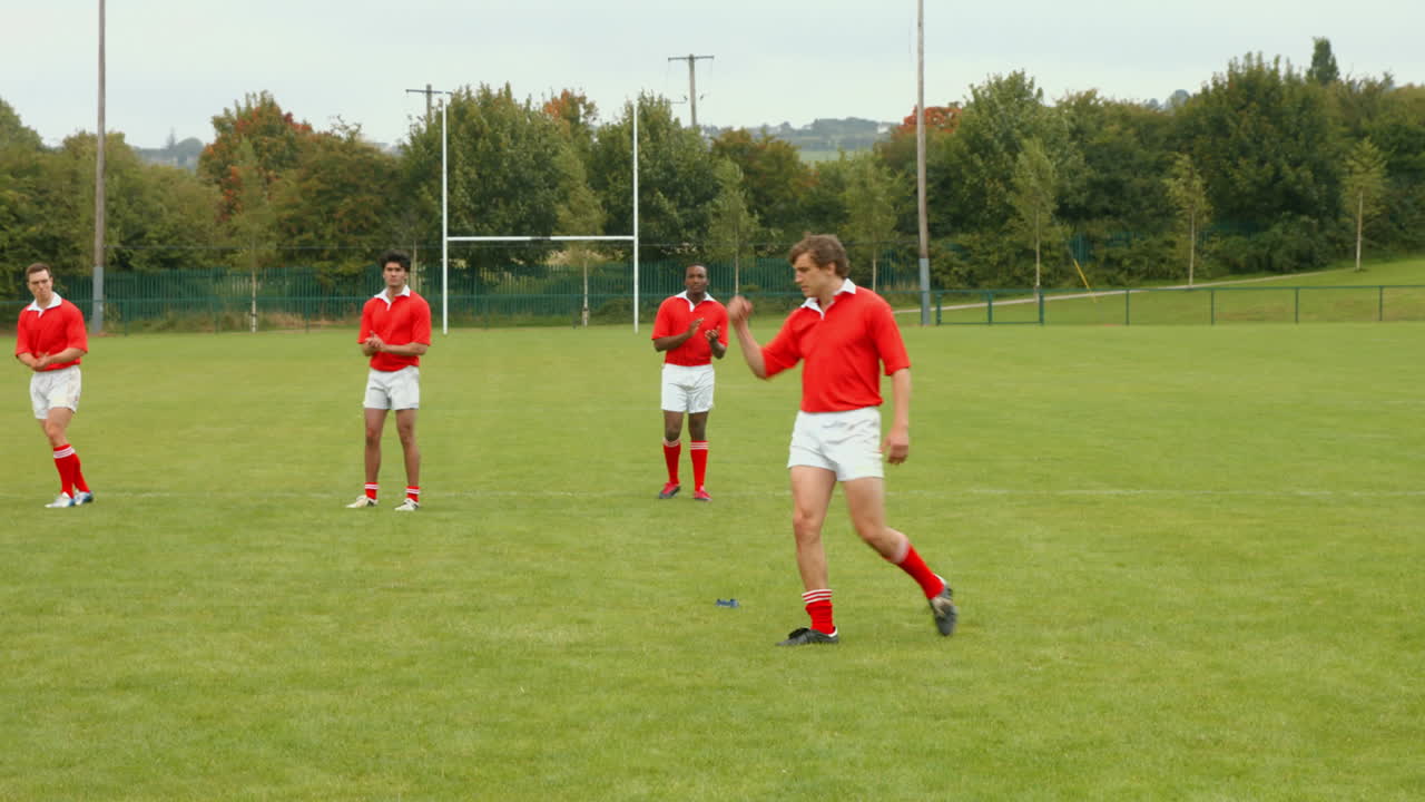 Rugby player taking a kick and scoring
