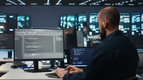 IT professional using PC to monitor energy consumption across blade servers