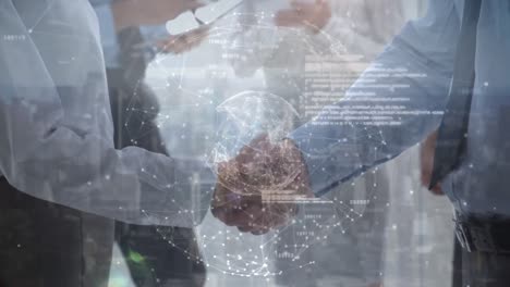 business people shaking hands and globe rotating