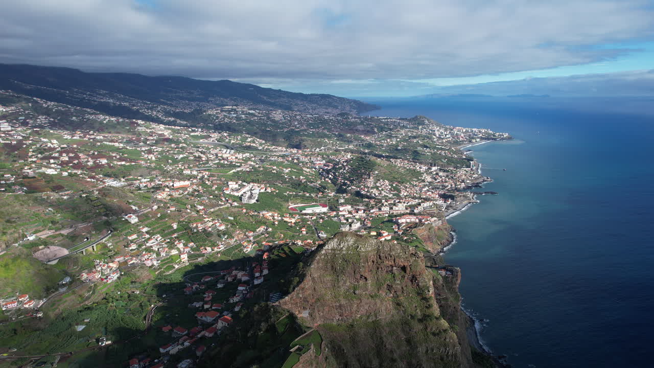 aerial shot taken from Cabo Girao and where you can see a panoramic view of the island of madeira, its mountains and also the ocean