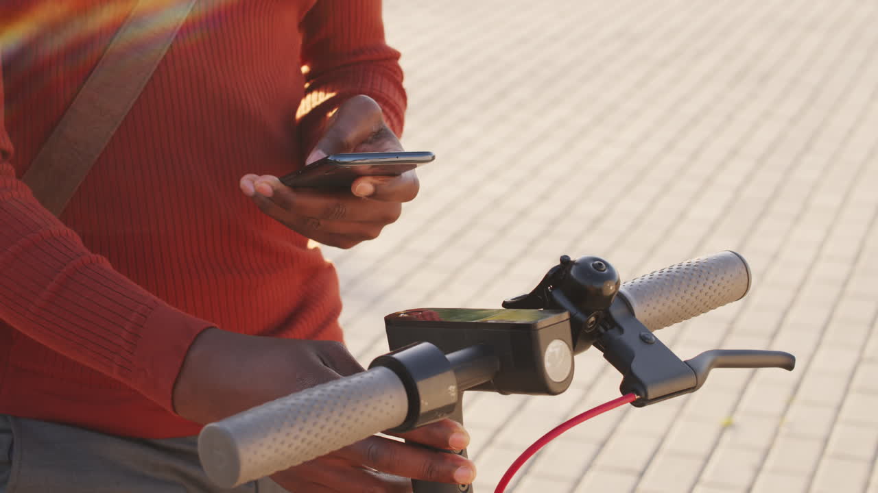 Man Activating Electric Scooter with Smartphone