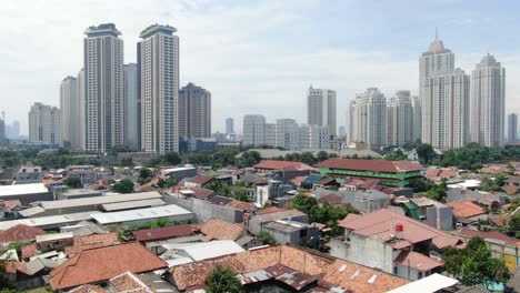 aerial view of beautiful downtown jakarta with drone flying over the densely populated residential area of jakarta city, indonesia