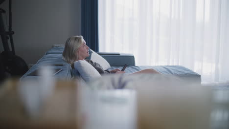 woman relaxing on couch and watching tv