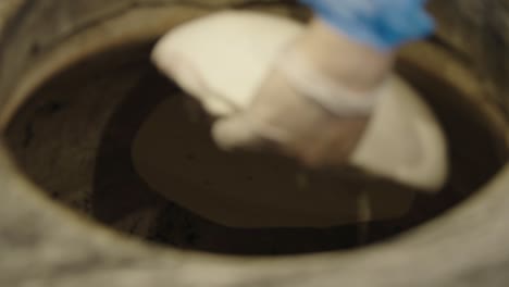 flat bread being baked on a high temperature open stone pit