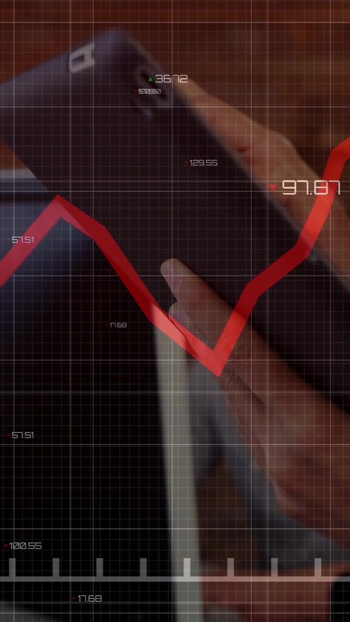 Vertical video: 2 analysts tapping tablet animating red chart moving updating finance values rising