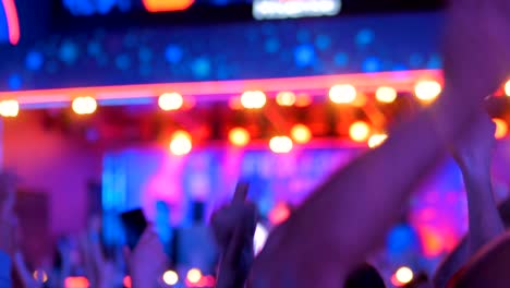 people partying at night electronic music concert in front of the stage