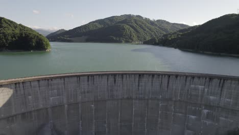 camera flies over a big concrete dam in prahova, muntenia, romania