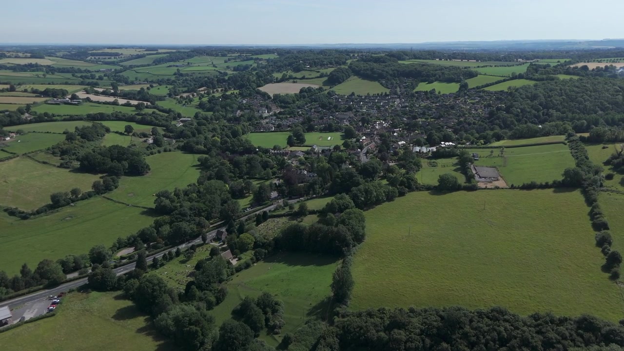 Quick aerial pan from Ashley to Box, Wiltshire on a summers day