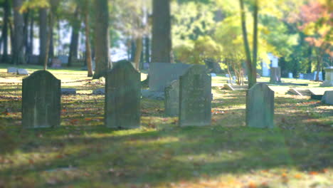 sunlight and shadow pass over a group of gravestones in time-lapse