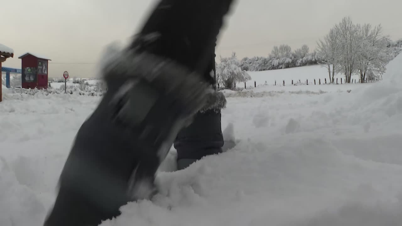 Snowy Countryside Scene with Person Walking