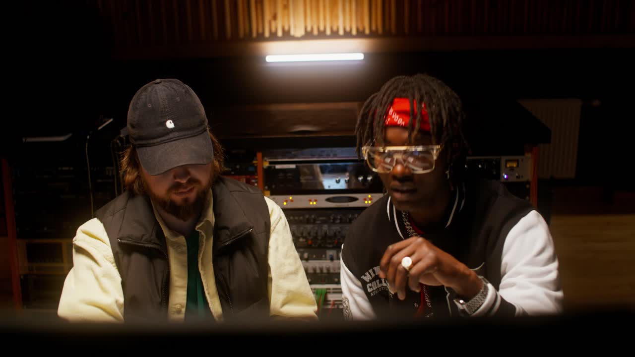 Two Musicians Collaborating in a Recording Studio