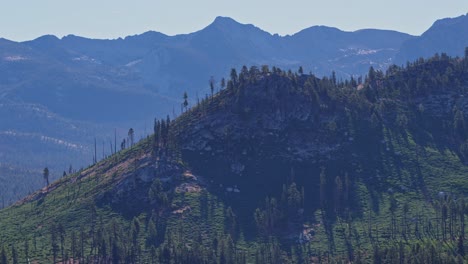 footage showing the majestic high sierra mountain range in yosemite national park, california, with the final patches of snow clinging to the rugged peaks.