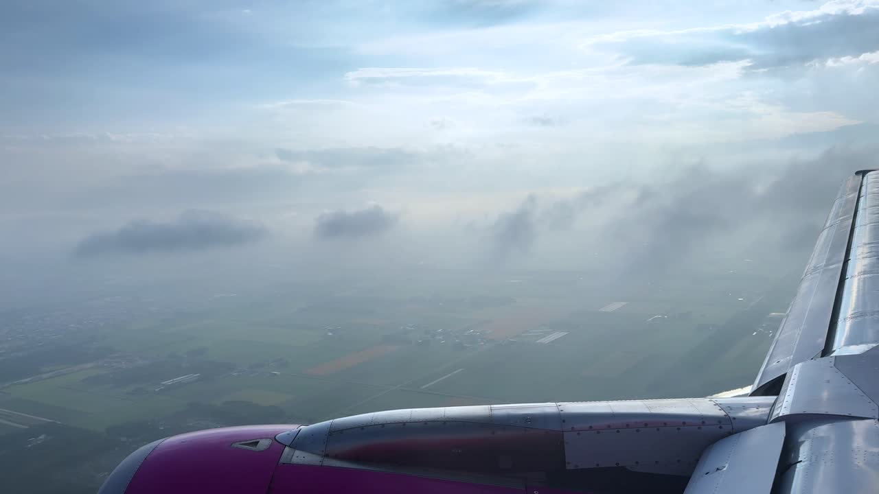 Aerial view from airplane window, flying through clouds, serene and peaceful