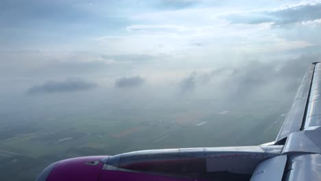 aerial view from airplane window, flying through clouds, serene and peaceful