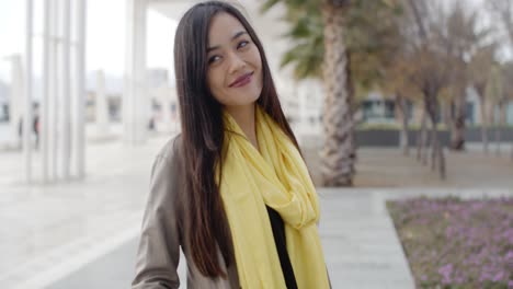 Stylish-young-woman-on-a-waterfront-promenade